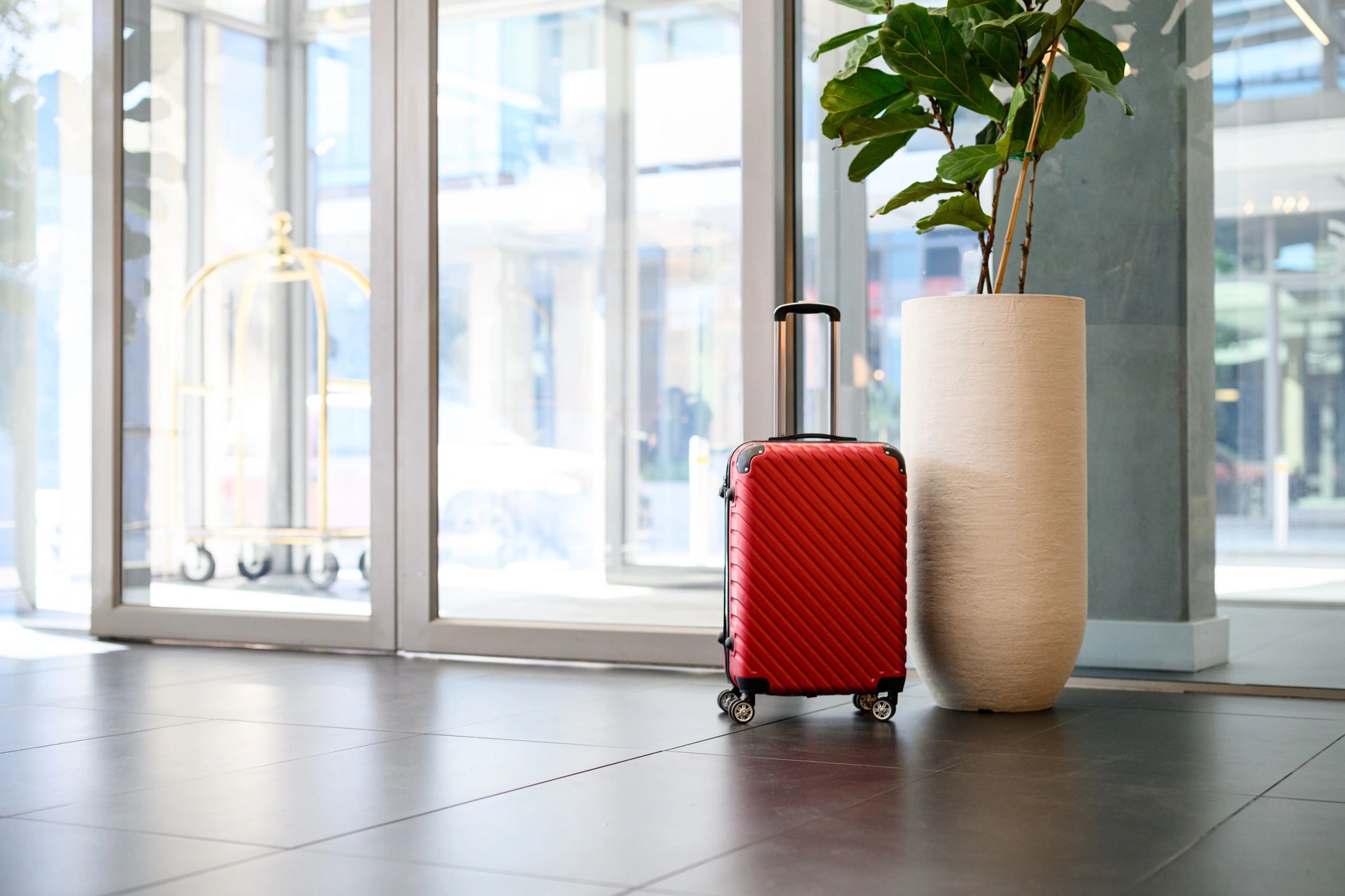 Suitcase in hotel lobby representing travel package inclusions